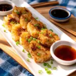 A slice of daikon cake topped with cream and herbs, showcasing a unique culinary delight.