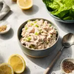 Healthy tuna salad in a bowl with fresh vegetables and herbs
