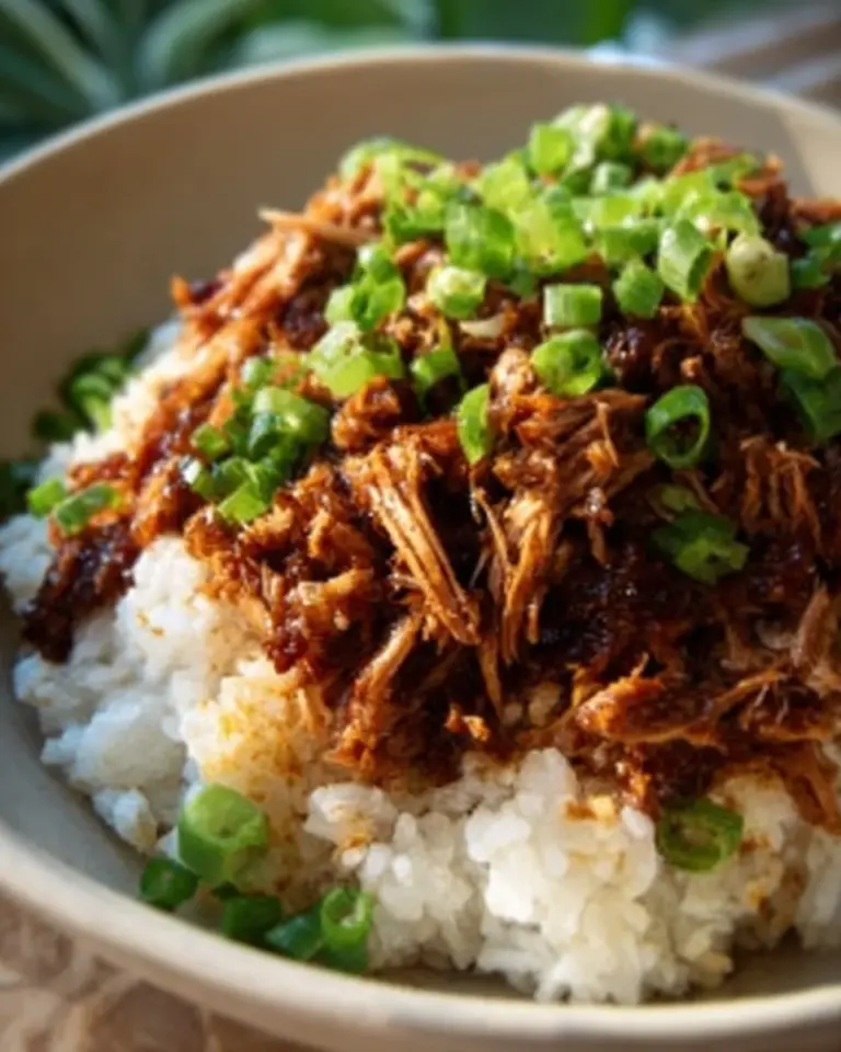 Delicious slow cooker teriyaki chicken served on a plate with rice and vegetables