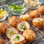 Delicious Thai coconut pancakes garnished with fresh coconut and syrup.